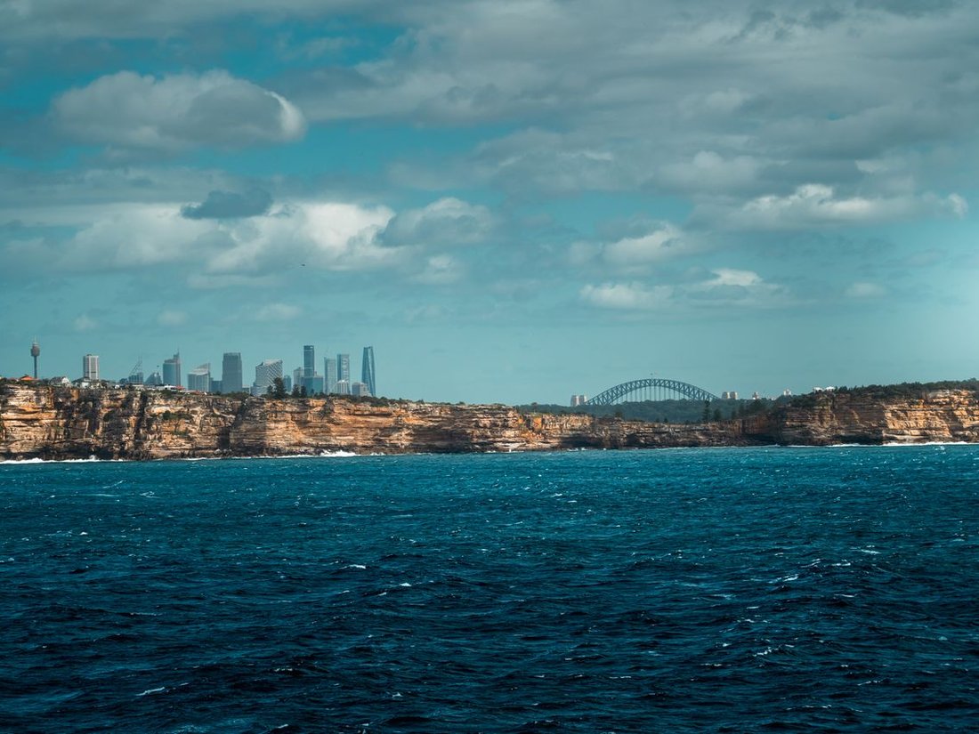 Sydney's sandstone cliffs at Dover Heights with city skyline