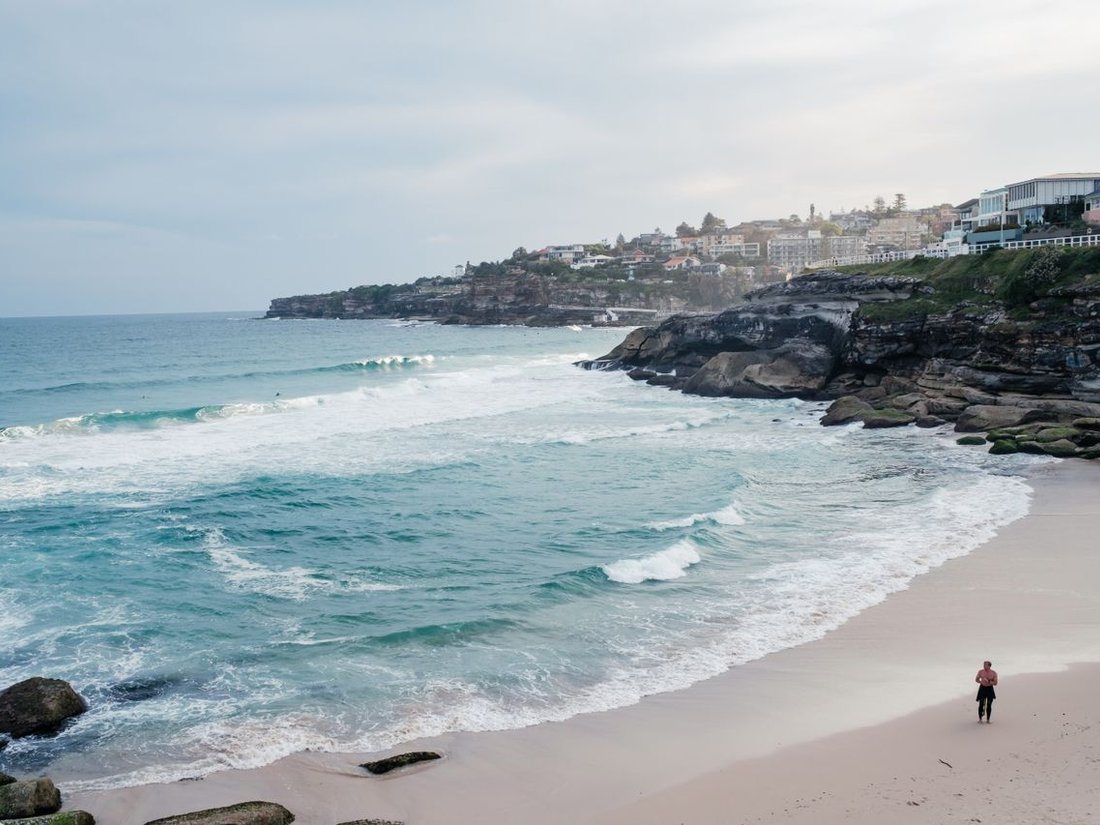 Person standing on the shore at Tamarama Beach