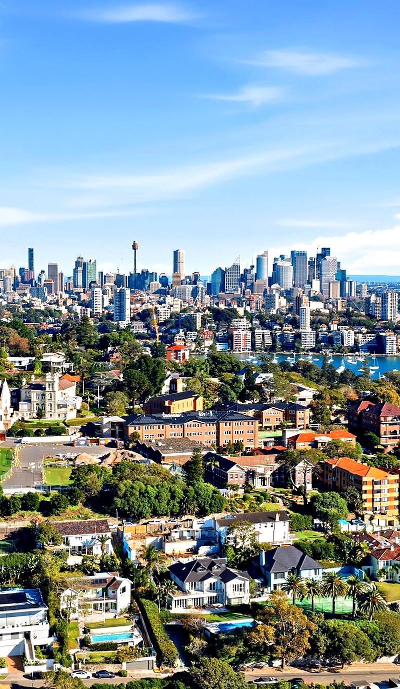 Aerial view over the rooftops of Sydney's Eastern Suburbs with the city skyline behind