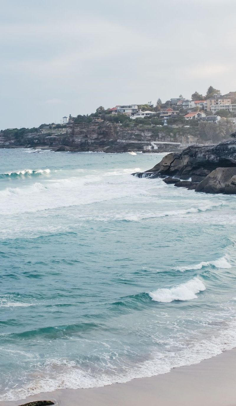 Person standing on the shore at Tamarama Beach
