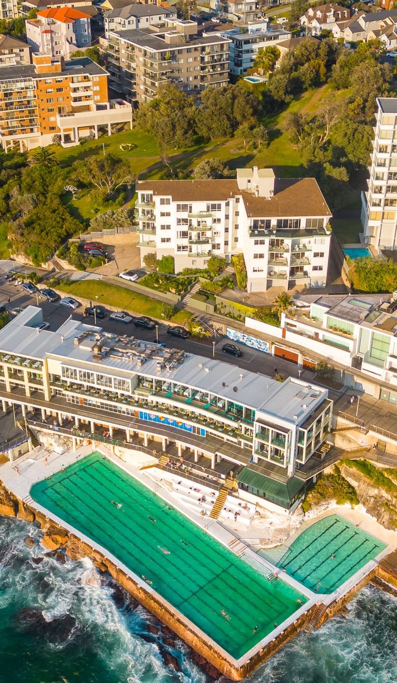The ocean pool at Bondi Icebergs and the rock shelf below the apartments, seen from the air